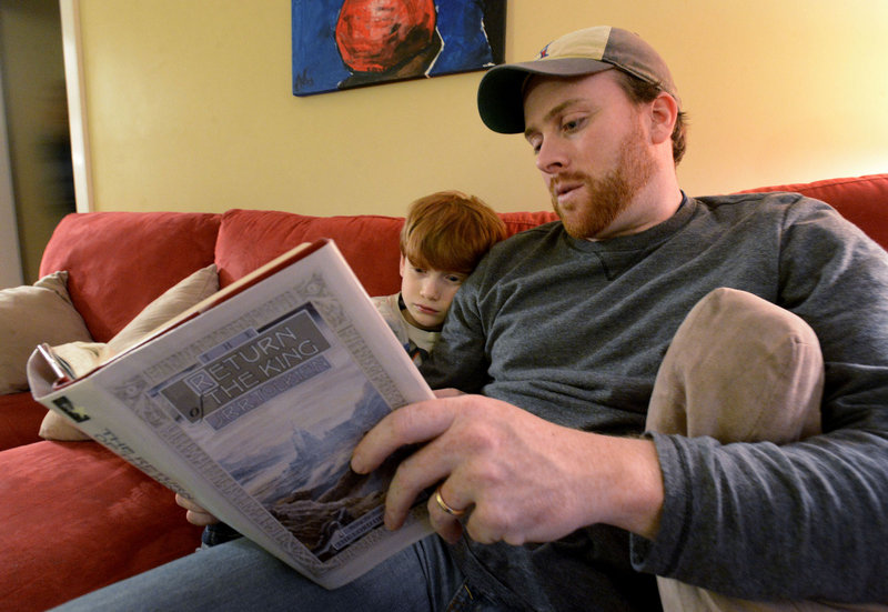 Jeff Shaw reads to his son Brayden, 7, from “The Return of the King” by J.R.R. Tolkien. They plan to see “The Hobbit: An Unexpected Journey.”