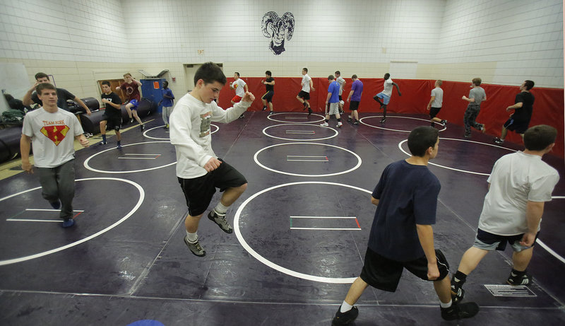 Iain Whitis of Cheverus warms up before practice Monday at Deering High. Whitis and several other independent wrestlers have found wrestling homes at other schools but can’t compete for those schools during dual meets and tournaments.
