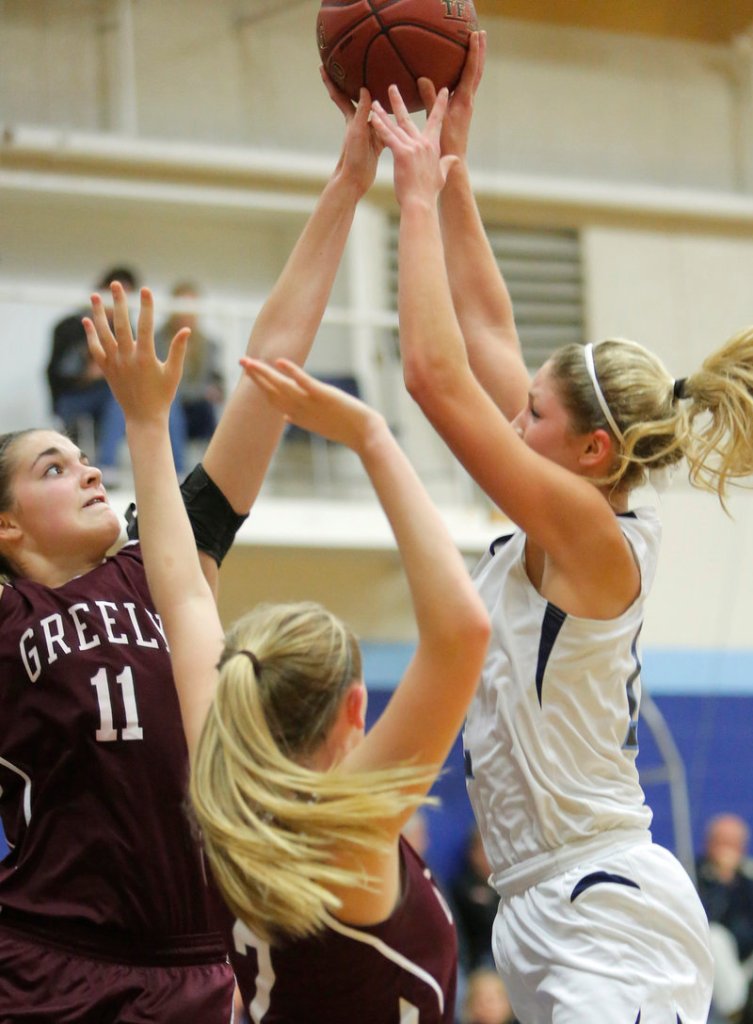 Ashley Storey of Greely blocks a shot by York’s Emily Campbell during their Western Maine Conference basketball game Monday night. York won, 39-34.