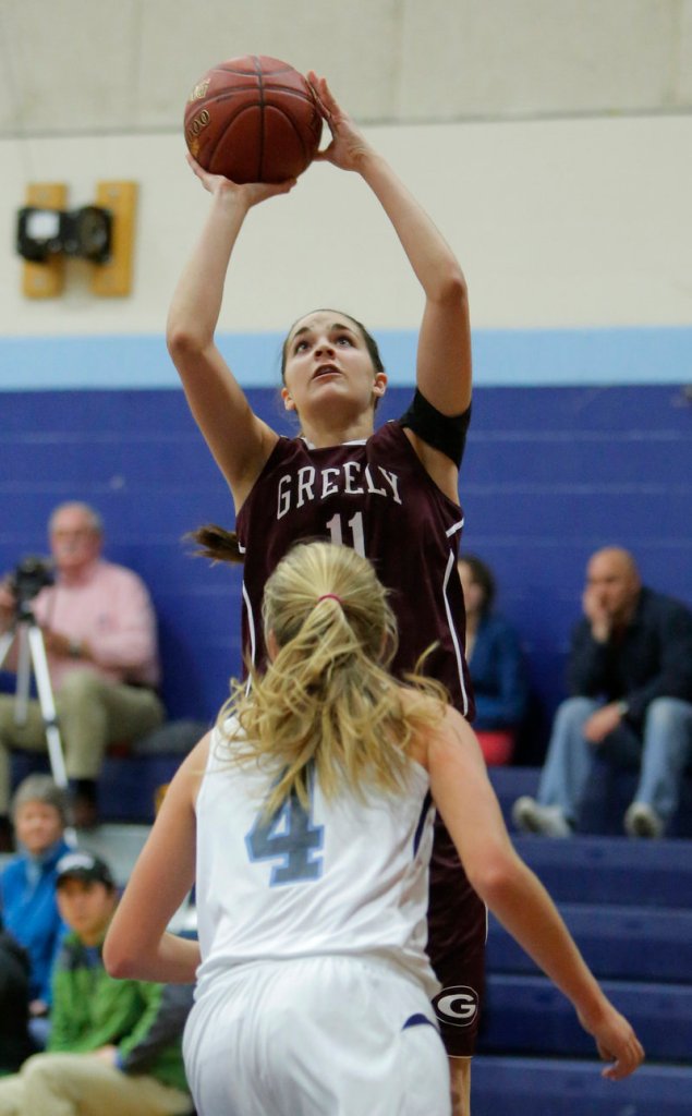 Ashley Storey of Greely puts up a shot over Shannon Todd of York during a game at York on Monday.