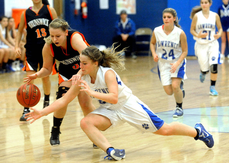 Brianna Soucy of Lawrence dives Tuesday night to try and knock the ball from Erica French of Brunswick during Lawrence’s 55-40 victory at home.
