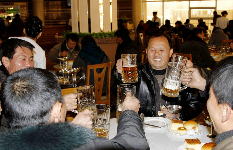 North Koreans toast with beer Wednesday at a Pyongyang diner after hearing news of the long-range rocket launch that is part of a quest to develop the technology needed to deliver a nuclear warhead.
