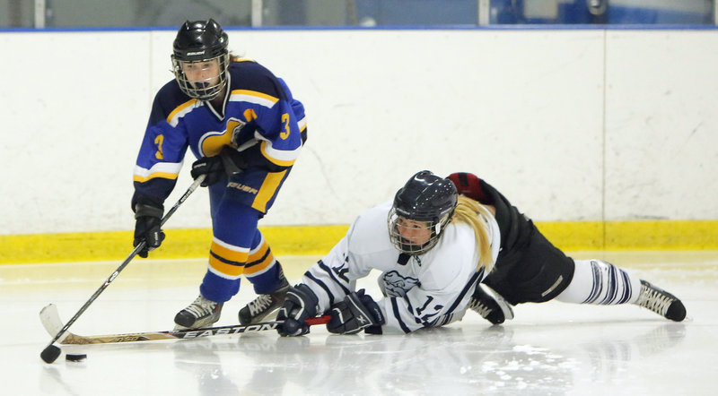 Katie Rutherford of Portland/Deering stretches Wednesday in an attempt to knock the puck from Abby Payson of Falmouth during their schoolgirl hockey game at the Portland Ice Arena. Falmouth improved to 3-3 with a 4-1 victory. The Bulldogs fell to 1-4-1.
