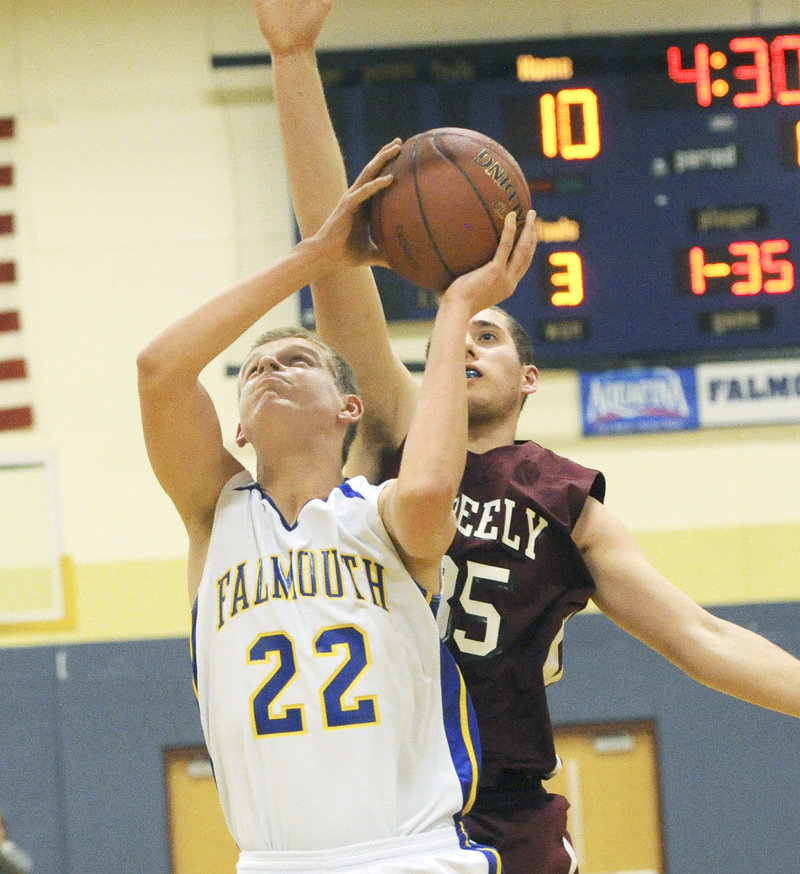 Jack Simonds of Falmouth prepares to shoot as Michael McDevitt of Greely approaches.