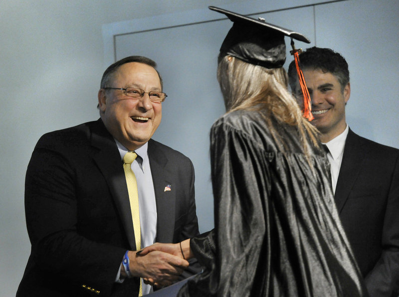 Governor Paul LePage congratulates graduate Heather Taylor a the Youth Building Alternatives Graduation ceremony at the Portland Public Library on Friday.