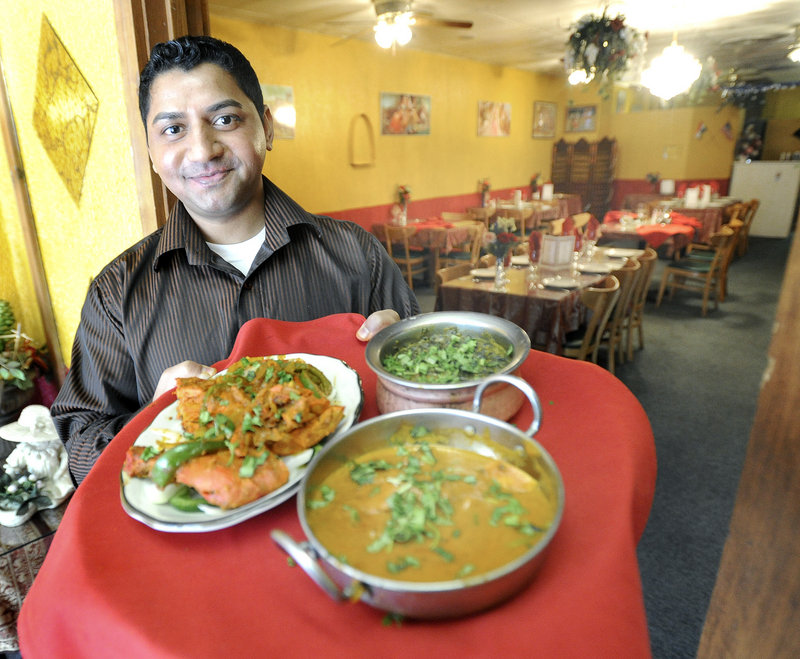 Rakesh Singh serves Tandoori Chicken, Saag Paneer and Chicken Tikki Masala during lunch at India Palace Restaurant on Congress Street in Portland. The restaurant is open daily from 11 a.m. to 3 p.m. and 5 to 10 p.m.