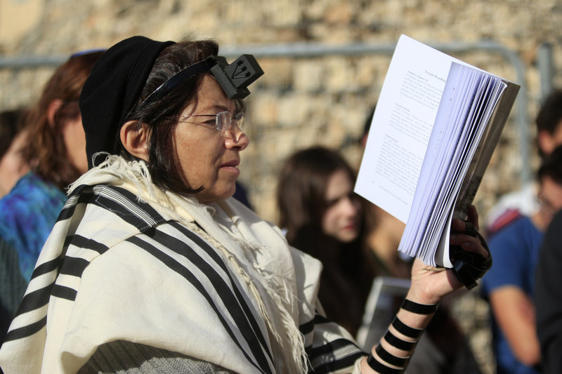 Israeli women members of the Women of the Wall don the trappings of men as they pray just outside the Western Wall, a holy site in Jerusalem’s old city.