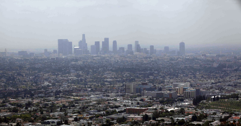 Downtown Los Angeles is covered in smog in this 2009 photo. For the first time in its 15-year history, the soot standard was cut, Friday, by the EPA. While many states are already in compliance, some, like California, have a long way to go.