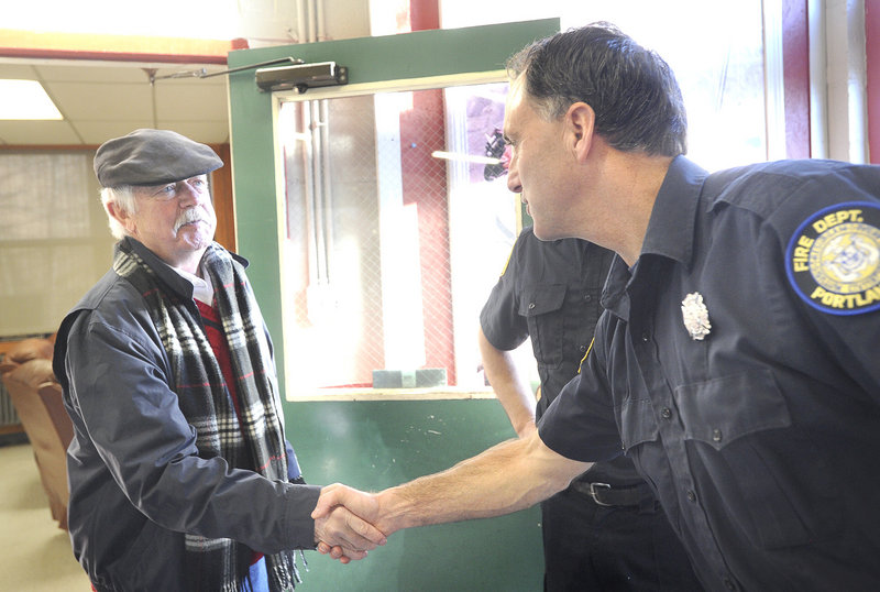 Robert Nannay of Old Orchard Beach shakes hands with Portland Firefighter Ralph Munroe as he visits the members of Ladder Company No. 3 on Stevens Avenue on Saturday. He thanked them for saving his life last October, using new protocols.