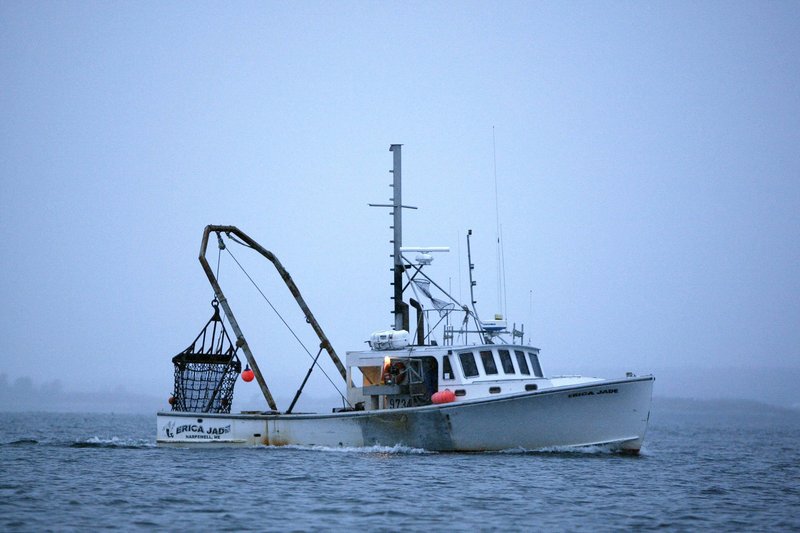 A scallop fishing boat heads out at dawn off Harpswell last year. Bottom-dragging scallopers are among the fishermen allowed in at various times to zones that exclude groundfishermen.