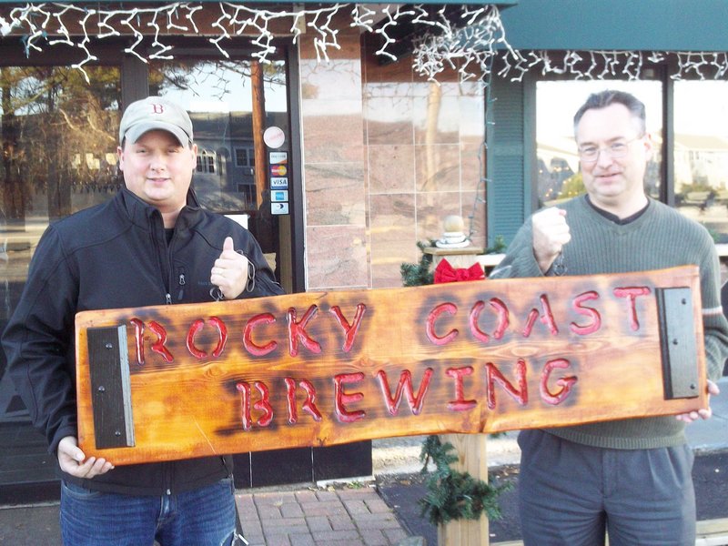 Jim Orser, left, and Andy Tomlinson display a sign they have yet to install at their brewery entrance in the Post Road Tavern in Ogunquit.