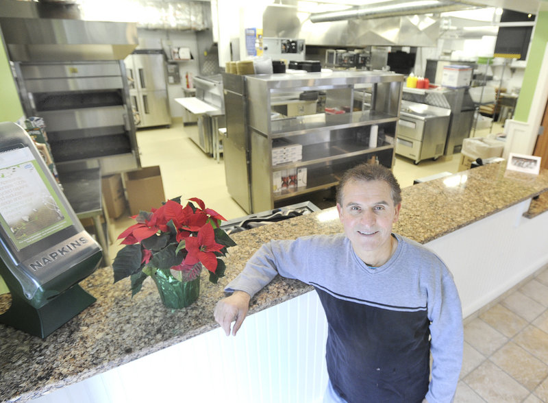 Gorham House of Pizza owner Angelo Sotiropoulos is ready to reopen Wednesday after a fire. Here, Sotiropoulos is seen in his restaurant's new kitchen on Monday, Dec. 17, 2012.
