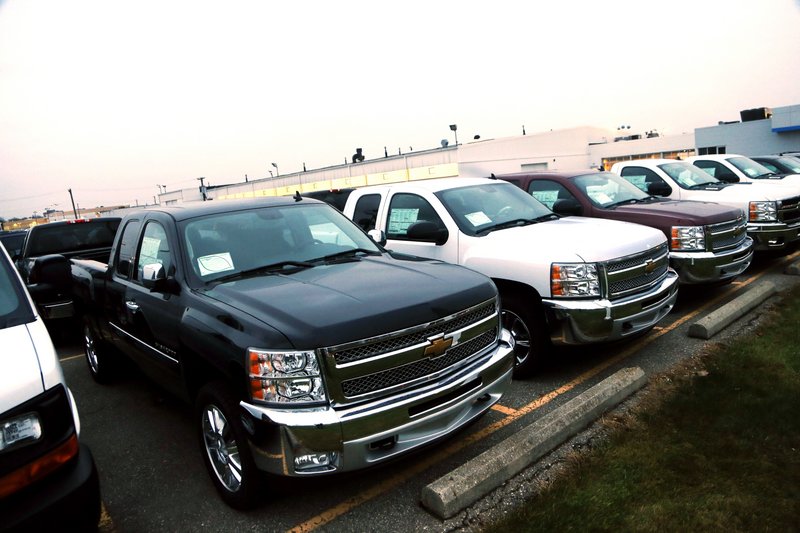 General Motors is offering generous deals to clear a growing inventory of Chevy and GMC pickup trucks, such as these Chevrolet Silverado pickups seen on a dealer's lot in Troy, Mich., on Monday.