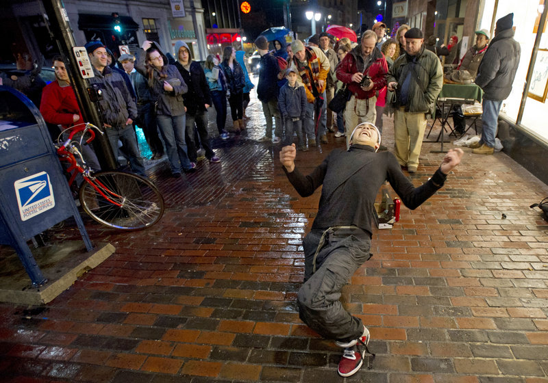 A crowd watches Rafael Alvarez, a Maine College of Art student, dance outside the Portland school during this month’s First Friday Art Walk. People who focus on how many artworks are sold during the art walk miss the point of the event, a reader says.