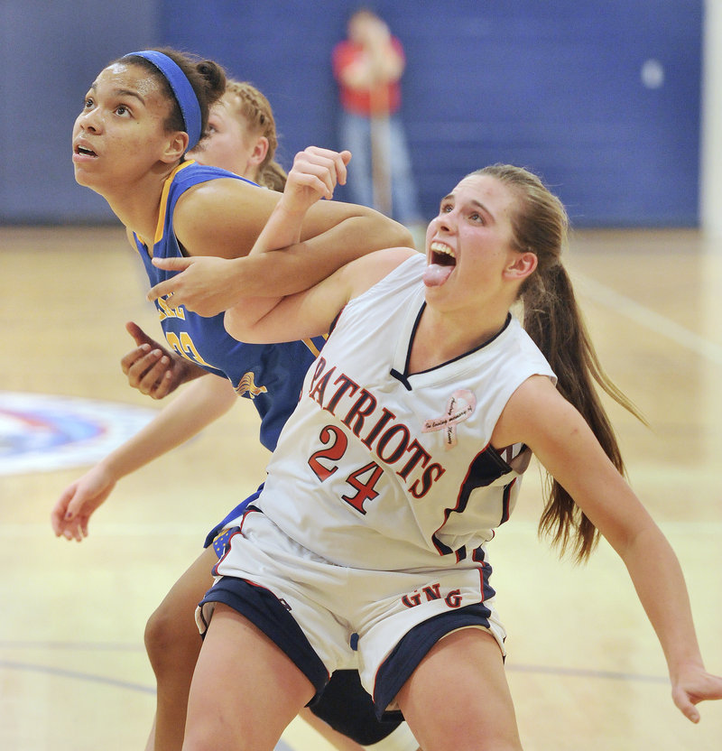 Maria Valente, right, of Gray-New Gloucester tries to fend off Lake Region's Tiana-Jo Carter for a rebound. Valente had 20 points for the Patriots.