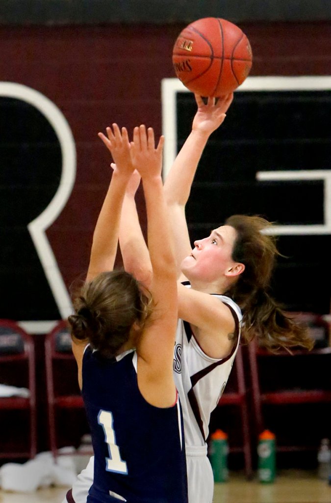 Aubrey Pennell of Freeport shoots over York’s Ruby Cribby. Pennell scored 11 points, while Cribby was one of four players in double figures for York, finishing with 10 points.