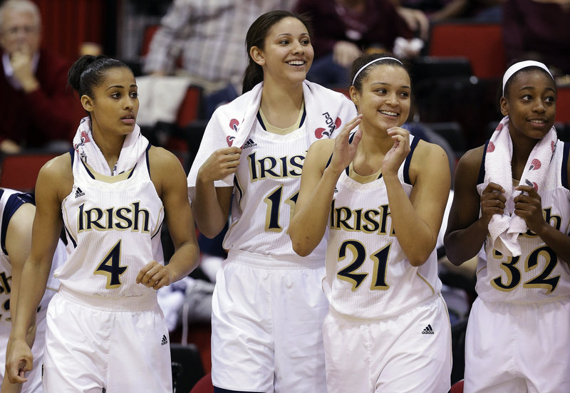Notre Dame’s Skylar Diggins, left, Natalie Achonwa, Kayla McBride and Jewell Loyd are all smiles as they watch the end of a 87-57 win over Kansas State in Las Vegas on Thursday.