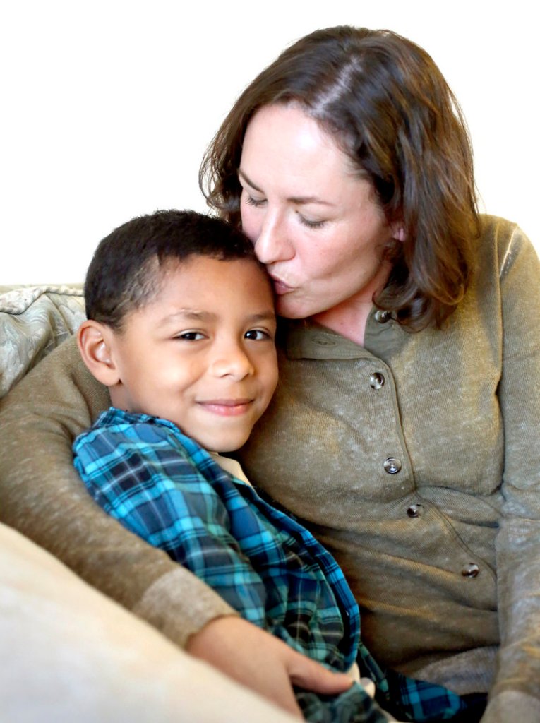 Max Ngabo, 8, and his mother Wanda Brann of Portland, in their home on Dec. 20, 2012.