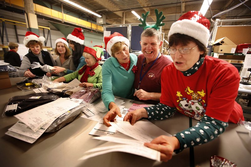 Santa Claus hats and antlers add a little fun to the fast-paced pressure for workers in L.L. Bean’s order fulfillment center in Freeport on Thursday. The company added 4,700 seasonal workers for the holiday push – every year the retailer goes into high gear to fulfill the crunch of orders for Christmas.