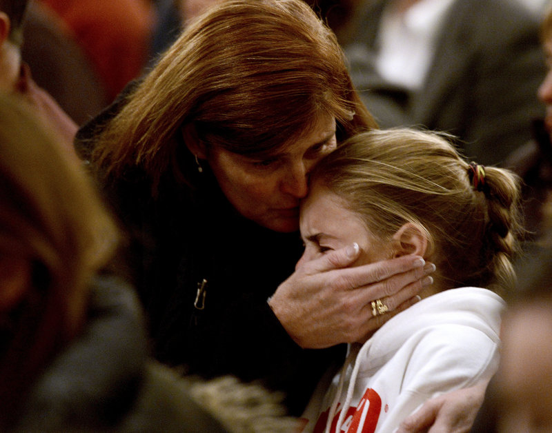 A woman comforts a young girl during a vigil service last week in Newtown, Conn., for victims of the Sandy Hook Elementary shooting. Programs for children with mental and neurological disorders help students adjust to the world around them, but “once they have finished public school, all assistance ends,” isolating at-risk young men, a reader says.