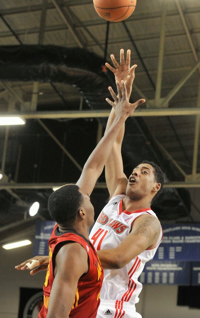 Maine’s Fab Melo extends for a shot against Fort Wayne on Friday night at the Portland Expo. Melo had eight points and six rebounds.
