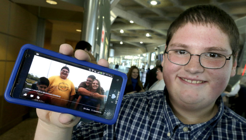 Jason, 16, shows a photo taken four months ago when he was nearly 100 pounds heavier.