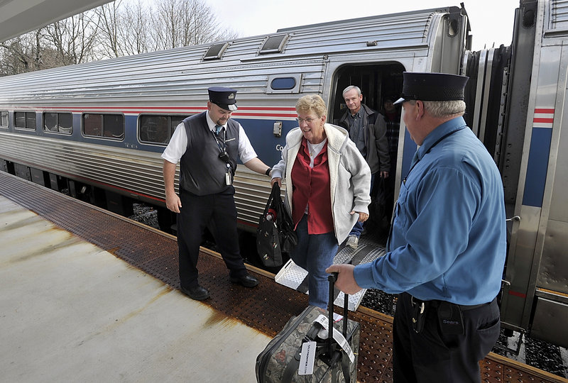 Downeaster conductor Chuck Moyer, left, helps passenger, Jean Townsend, who lives in Naples Fla., as she leaves the train in Freeport.
Press Herald file photo