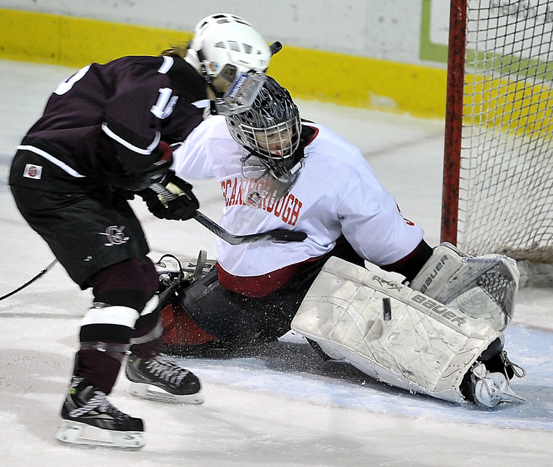 Scarborough goalie Devan Kane extends her left pad to stop a breakaway bid by Greely’s Danita Storey during Saturday’s game at the Cumberland County Civic Center. Kane made 38 saves in a 2-2 tie.