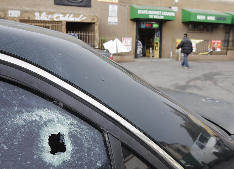 This Nov. 29, 2011, file photo shows a bullet hole in a window of a car at a liquor store parking lot in Oakland, Calif., after a shooting. A hail of gunfire along the Oakland street left eight people wounded, including a 1-year-old boy.