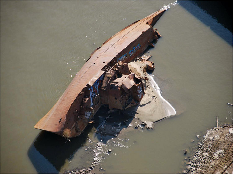 A World War II minesweeper is exposed in its Mississippi River grave. Once moored as a museum at St. Louis, it was torn away by floods two decades ago. Now it – and hundreds of other sunken boats – are visible once again thanks to water levels lowered by a lack of rain.