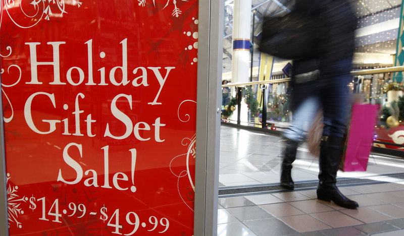 A store at the CambridgeSide Galleria mall in Cambridge, Mass., advertises a sale Monday. Early figures point to a ho-hum season for retailers despite efforts to lure shoppers over the weekend before Christmas.