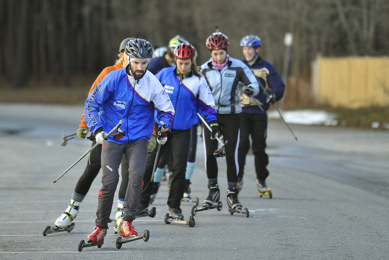 Aaron Duphily, a Cheverus High teacher, leads the group of high school skiers known as Portland Nordic at the start of a training session. There was bare pavement that day, but good skiing is on the way.