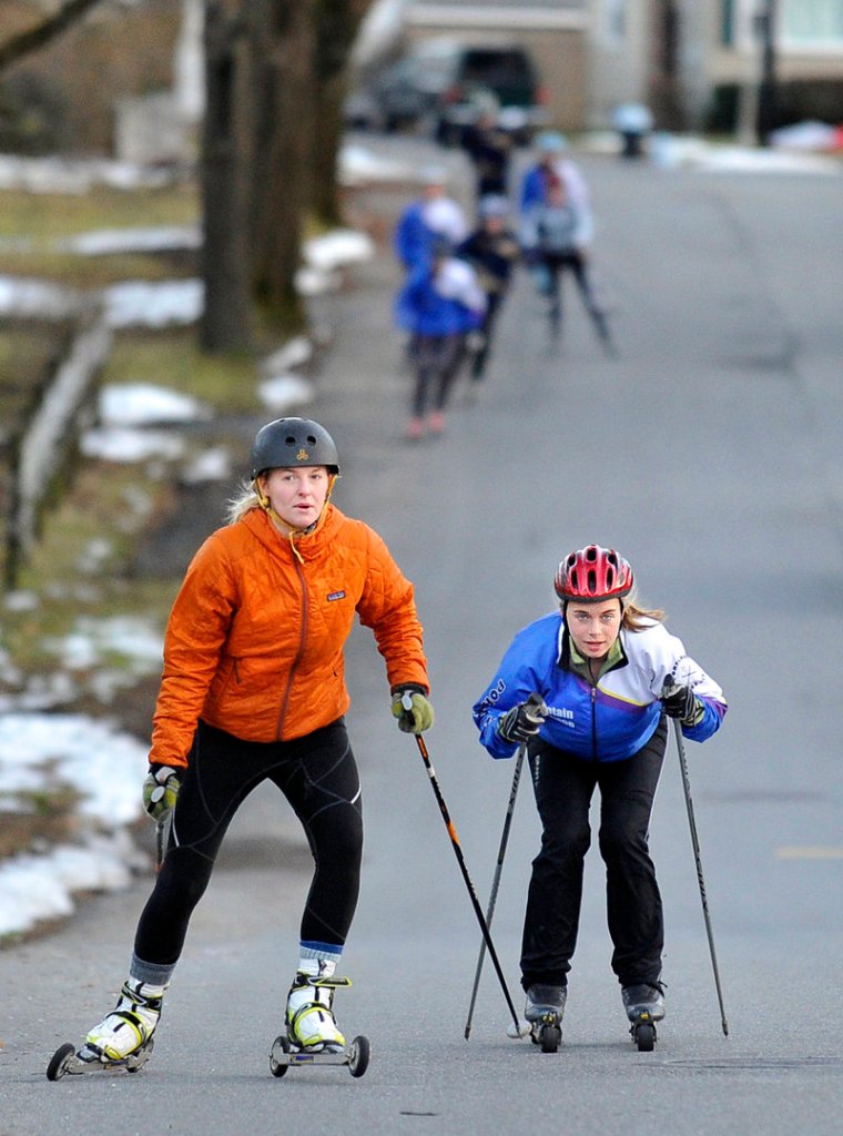 Sadie Sarvis, left, a senior at Casco Bay High, and Abby Popenoe, a senior at Portland High, have their sights on a state title while training with Portland Nordic, a local group.