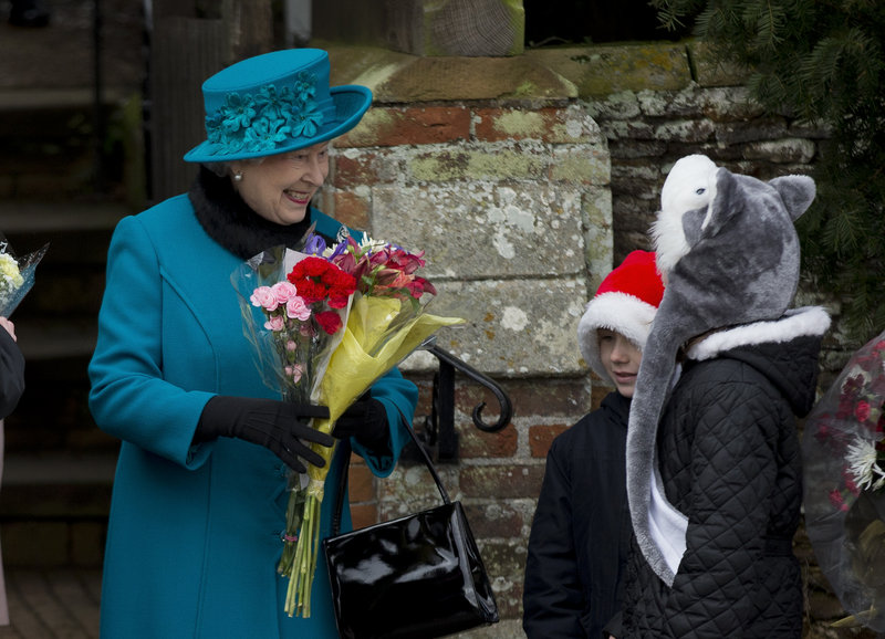 Britain’s Queen Elizabeth II receives flowers from children after attending the royal family’s traditional Christmas Day service in Sandringham.