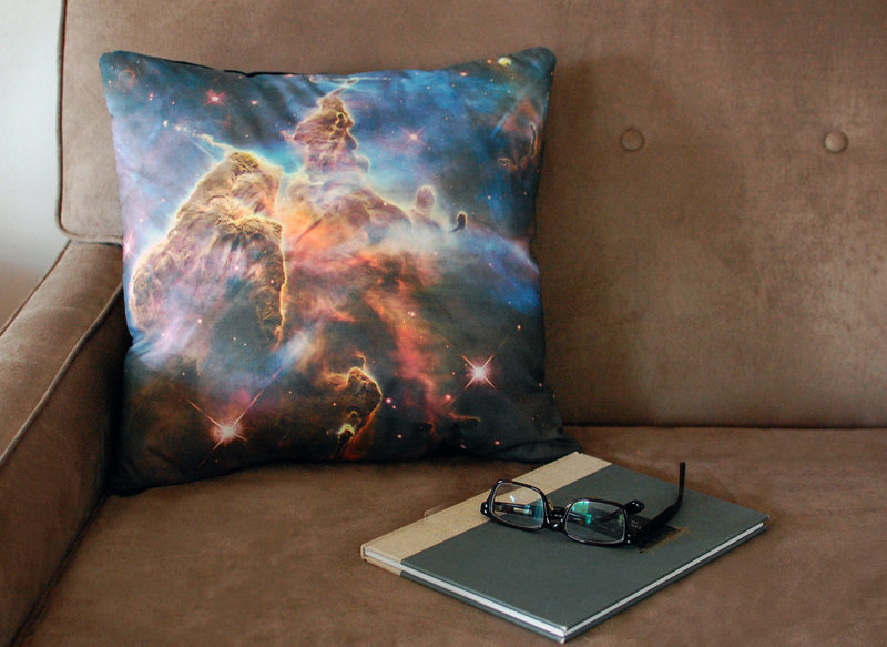 A Pillars of Creation pillow cover printed with an image from the Hubble telescope.