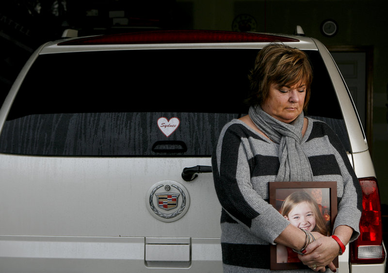 Judy Neiman of West Richland, Wash., holds a photo of her daughter, Sydnee, who she killed in 2011 while backing up her vehicle in a bank parking lot. Nieman is pleading for the government to implement rear-view safety measures that were ordered in 2008.