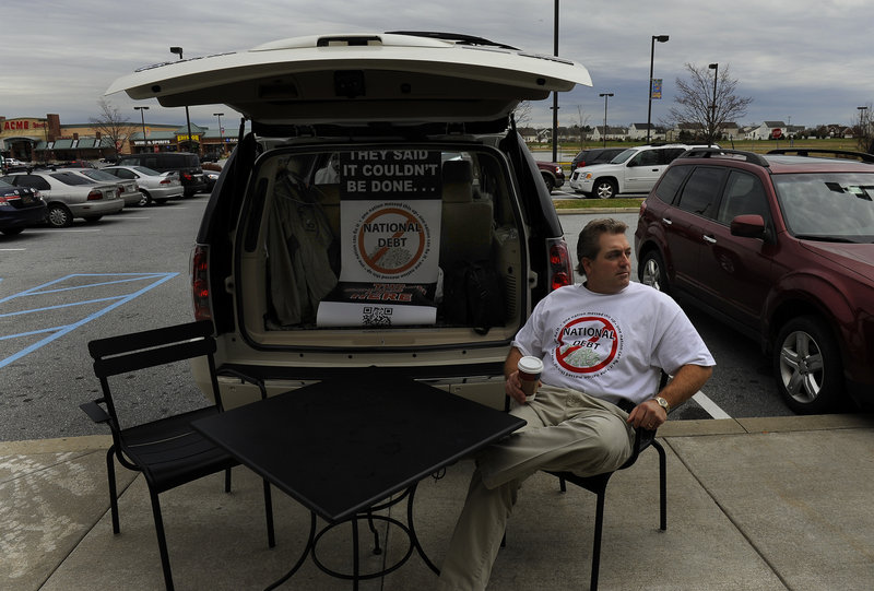 Scott Soucy sits in Middletown, Del.,waiting to talk to passersby about the national debt.