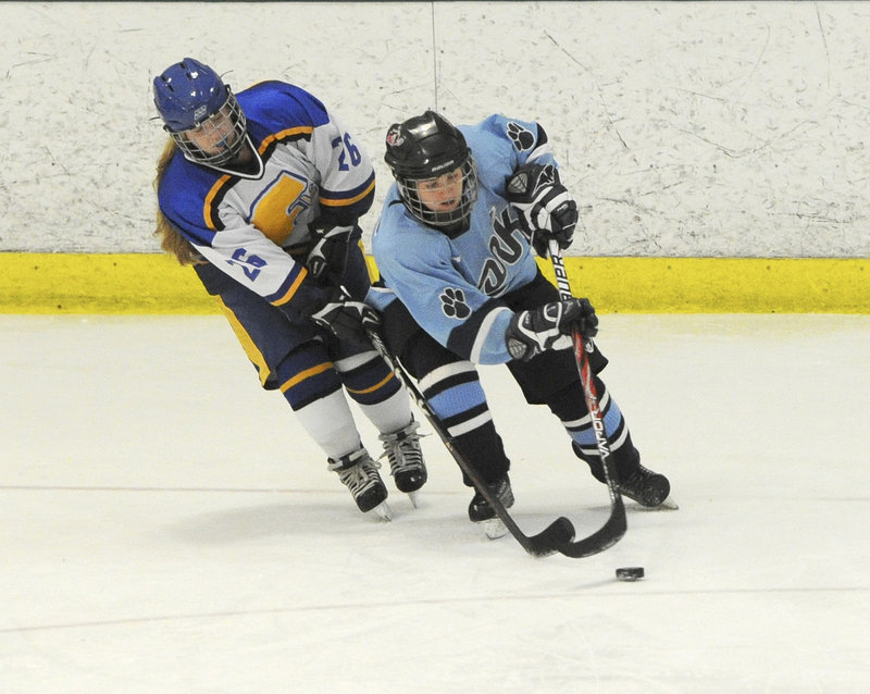Sarah Hutcheon of Falmouth, left, chases Tori Stocks of York for the puck. Falmouth ended York’s five-game undefeated streak.