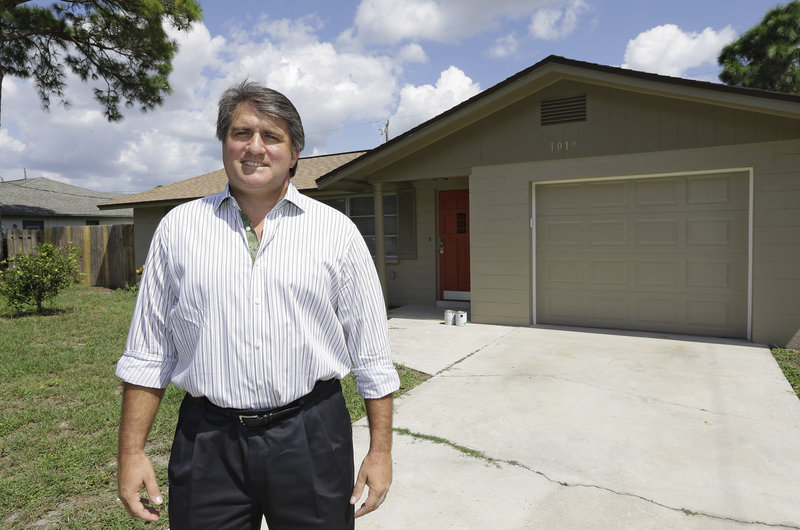 Andrew Neitlich stands outside one of his investment homes in Venice, Fla. Neitlich once worked as a financial analyst, picking stocks for a mutual fund, but like many others he is selling his stock now. He says he prefers to invest in real estate because it’s something he can “control.”