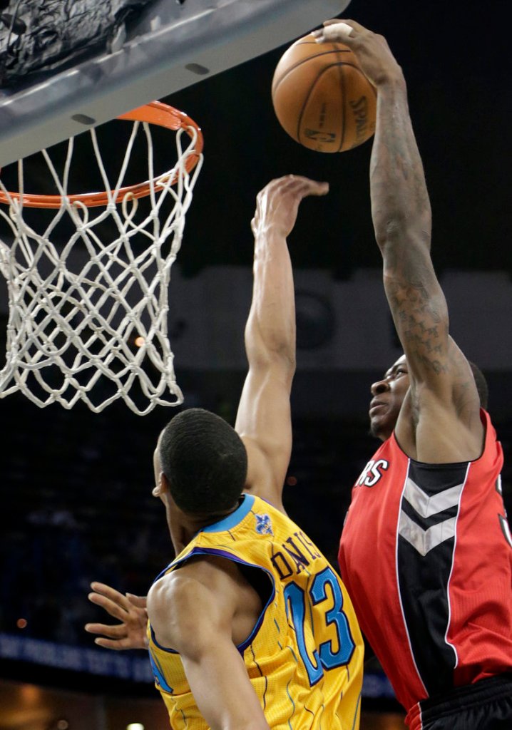 New Orleans power forward Anthony Davis (23) tries to block a shot by Toronto’s Ed Davis during first-half action of Friday’s game in New Orleans.