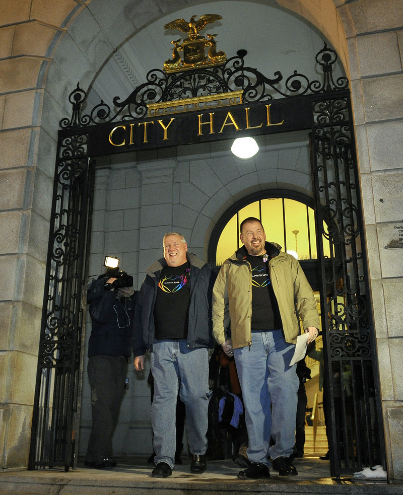 The first to wed: Michael Snell, left, and Steven Bridges leave Portland City Hall early Saturday after becoming the first gay couple to be married in Maine. The mayor said theirs “may be the most covered marriage” in the state’s history.