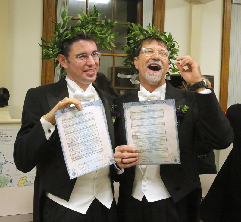 Jamous Lizotte, left, and Steven Jones display copies of their marriage license after they were wed Saturday in a ceremony at Portland City Hall.