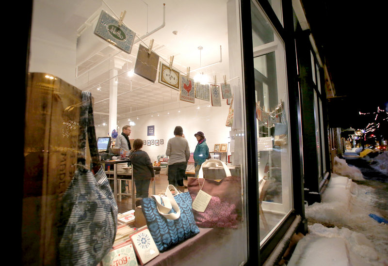 People visit and look at art in Engine, an arts-driven nonprofit, during the monthly Biddeford ArtWalk along Main Street in Biddeford on Friday.