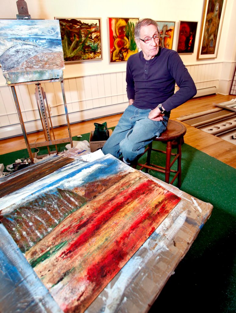 Mixed media artist Roland Salazar Rose in his live/work studio apartment among his new work.