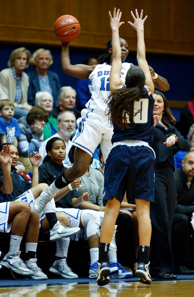 Duke’s Chelsea Gray makes a leaping attempt to pass against Monmouth’s Chevannah Paalvast during the Blue Devils’ 73-32 win at Durham, N.C., on Sunday.