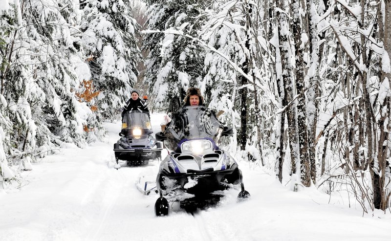 Ernie Rice, front, and Dennis Harris, both members of the Belgrade Draggin Masters club, groom snowmobile trails on Sunday. The early snow is a blessing for area snowmobilers.