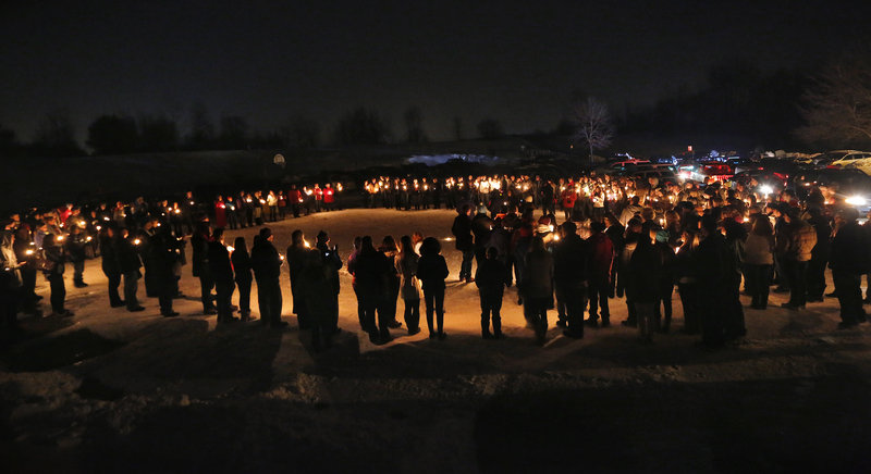 Hundreds attend a vigil at Rotary Park in Biddeford on New Year's Eve to remember Derek Thompson, 19, and his girlfriend Alivia Welch, 18, whow ere shot and killed by their landlord James Pak on Saturday.