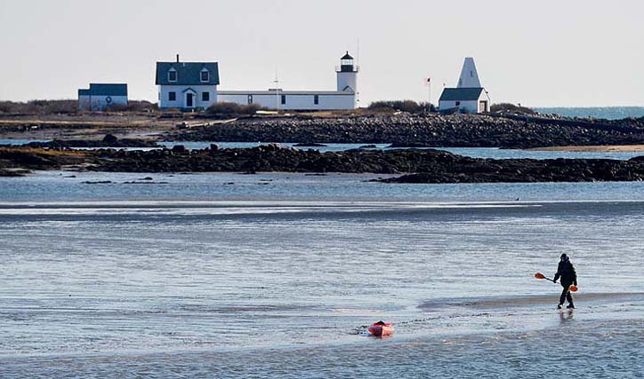 Maine Warden Service Sgt. Tim Spahr searches Monday near Goat Island Lighthouse off Cape Porpoise for Zachary Wells and Prescott Wright, who've been missing from Kennebunkport since Wednesday.