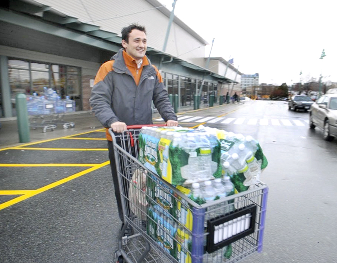 Alen Saric assistant general manager of Residence Inn in Portland, leaves Hannaford Supermarket with his second load of drinking water for his customers. A boil drinking water alert was issued for Portland by the Portland Water District after a water main broke.