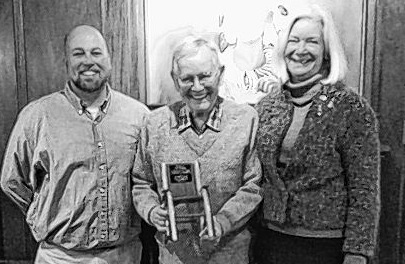 Longtime Pine Tree Society Kids’ Project volunteer Tom Morgan, center, receives a special plaque at his recent retirement party. With him are Pine Tree’s volunteer coordinator Jeremy Lucas, left, and Executive Director Anne Marsh.